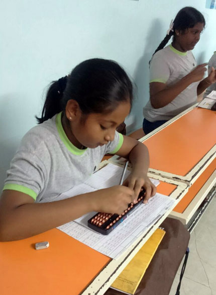 Picture of students working out problems on an abacus board at AbacusMaster, Bangalore branch