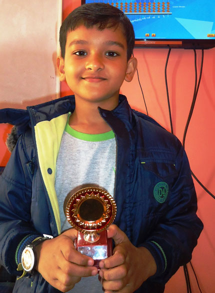 Picture of a student posing with their abacus trophy at AbacusMaster, Guwahati branch