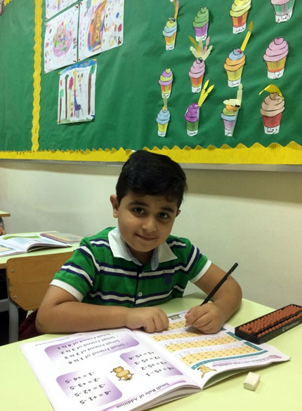Picture of a student working out problems on an abacus board at AbacusMaster, Muscat branch