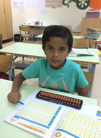 Picture of a young boy working out abacus problems at AbacusMaster, Muscat branch
