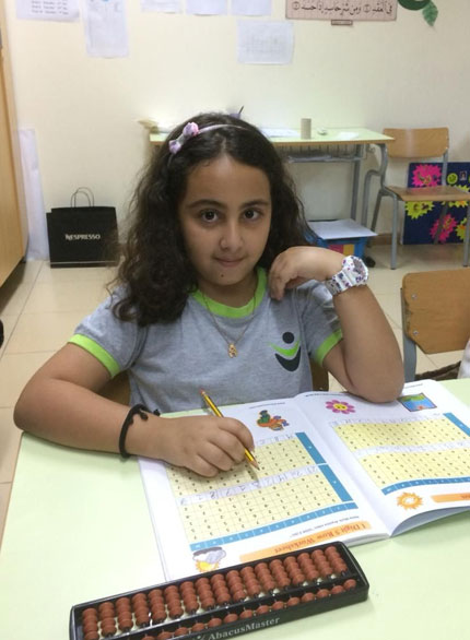 Picture of a young girl working out abacus problems at AbacusMaster, Muscat branch
