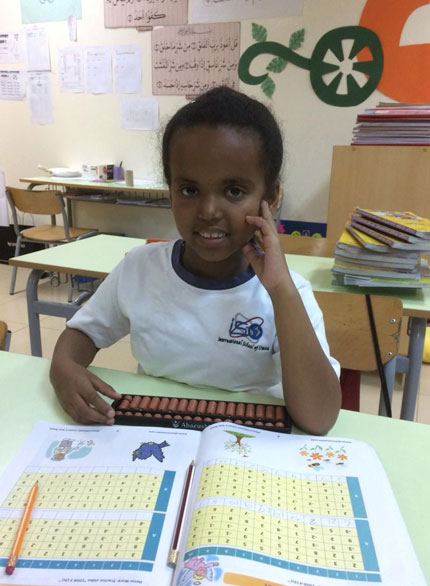 Picture of a student working out problems on an abacus board at AbacusMaster, Muscat branch