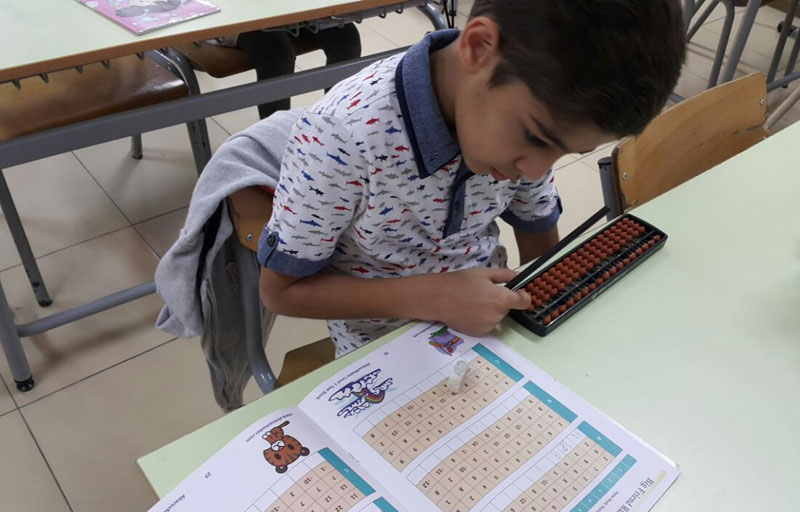 Picture of students working out problems on an abacus board at AbacusMaster, Muscat branch