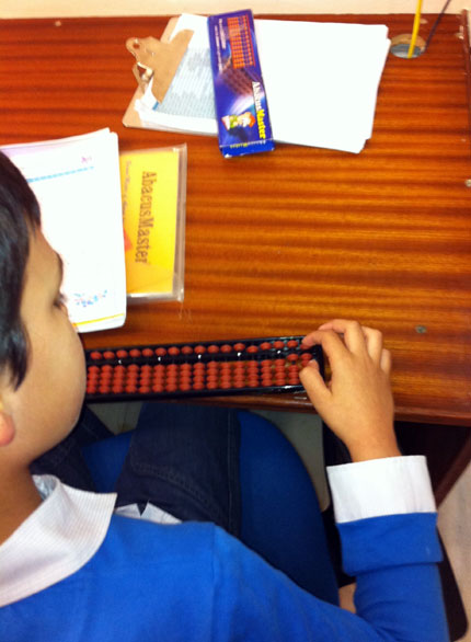 boy doing abacus calculation