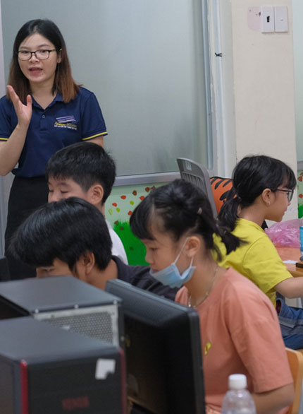 Picture of a lady teacher explaining concepts of abacus to young students at AbacusMaster, Vietnam branch