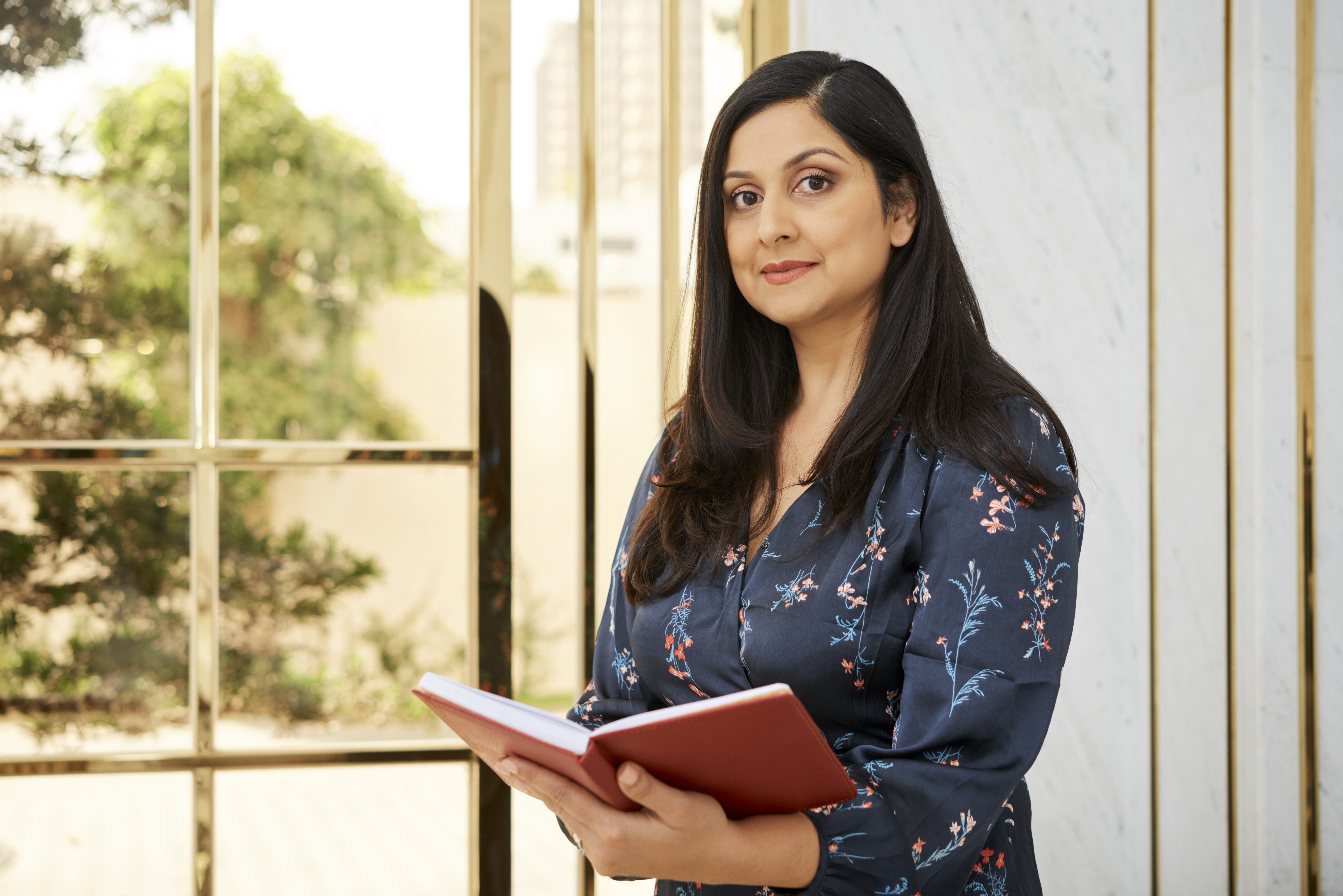 A woman entrepreneur and franchise owner, wearing formals.