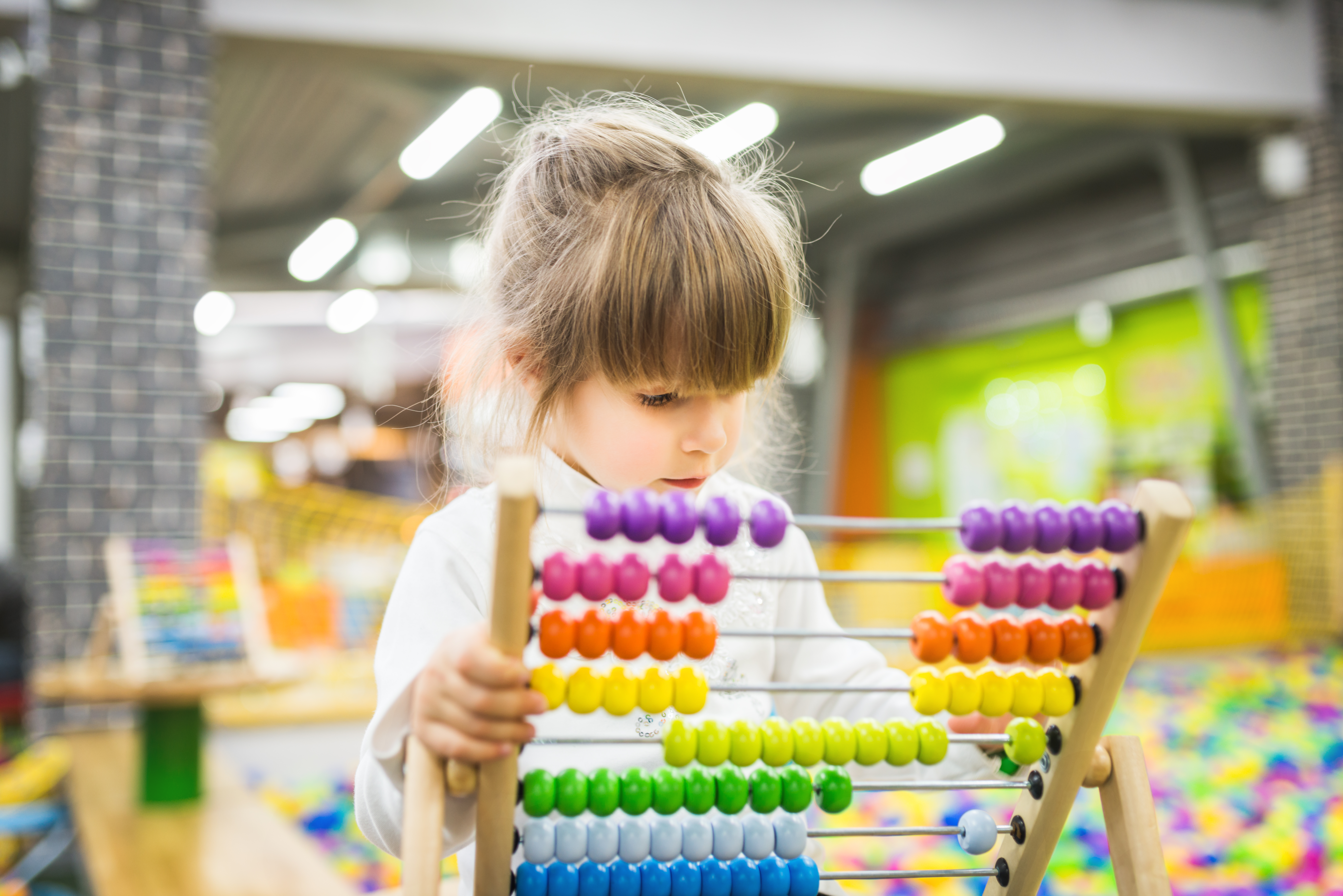Little child learning to count with a colorful abacus
