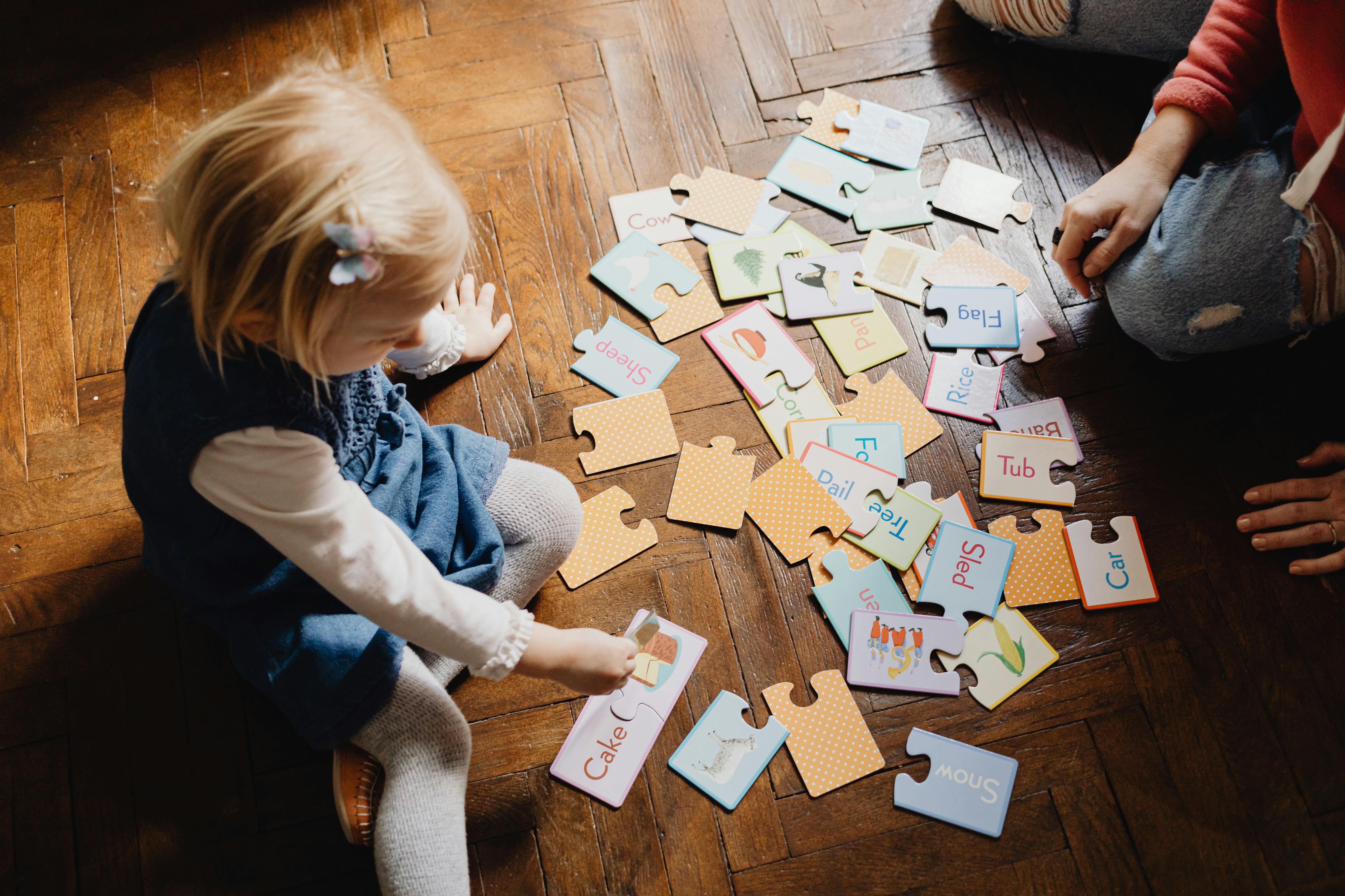 a box containing English letters with happy kids around and on the box, with a signal board written ‘English’