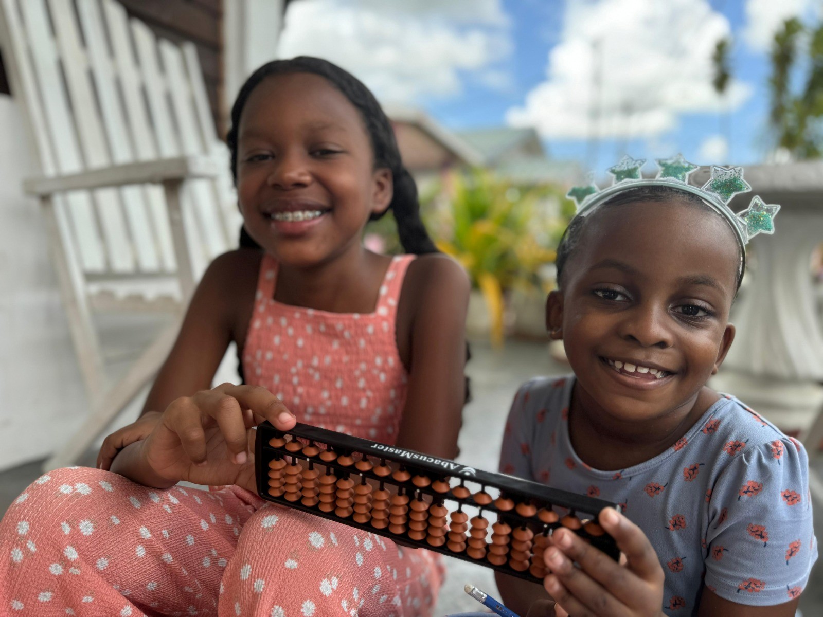 Two kids holding colorful abacus